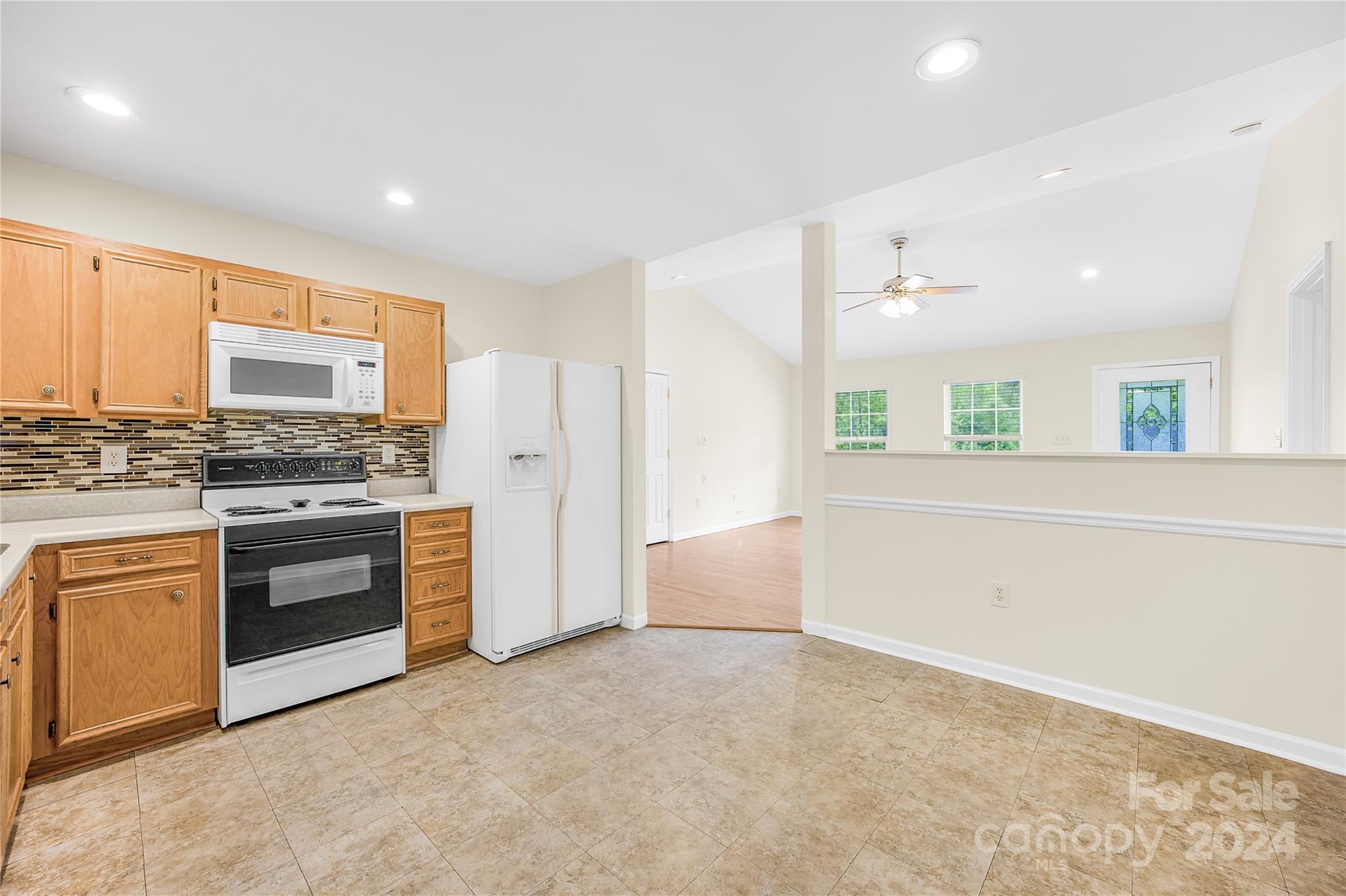 220 Shenandoah Loop Troutman, NC 28166 - Photo 12 of 26 a kitchen with stainless steel appliances a stove and a refrigerator