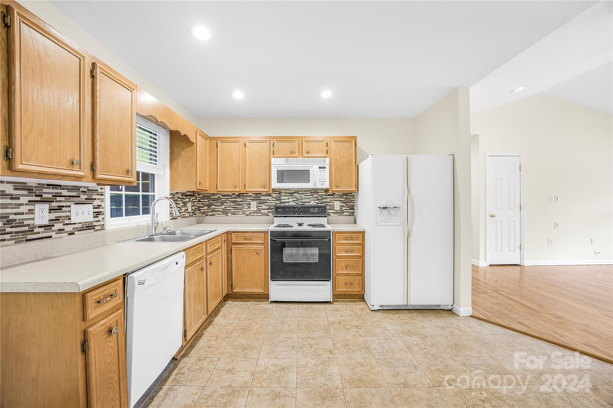 220 Shenandoah Loop Troutman, NC 28166 - Photo 13 of 26 a kitchen with stainless steel appliances granite countertop a stove a sink and a refrigerator