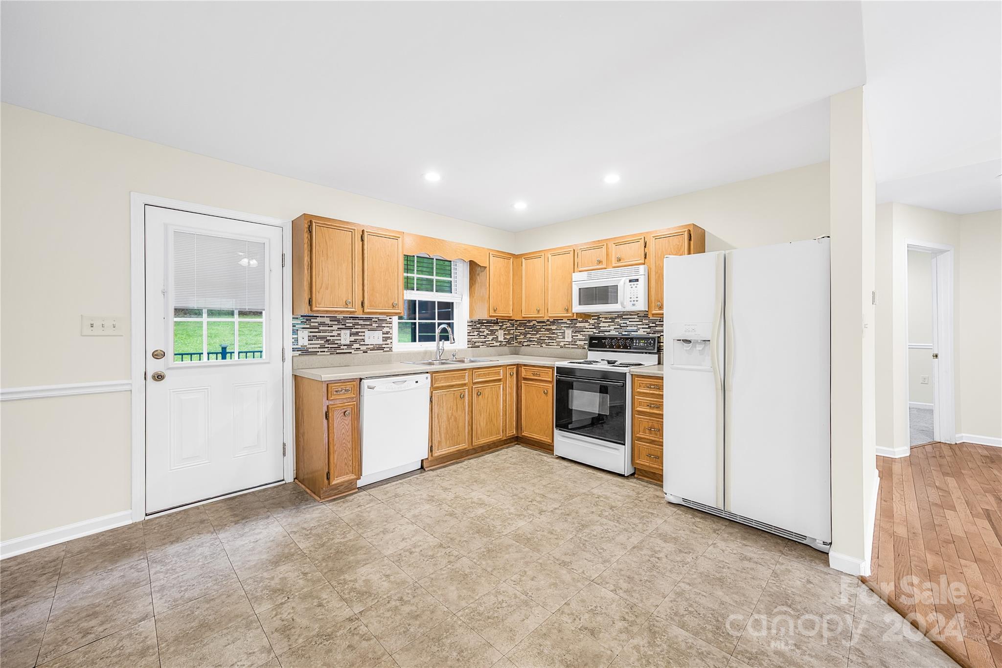 220 Shenandoah Loop Troutman, NC 28166 - Photo 14 of 26 a kitchen with stainless steel appliances a refrigerator sink and cabinets