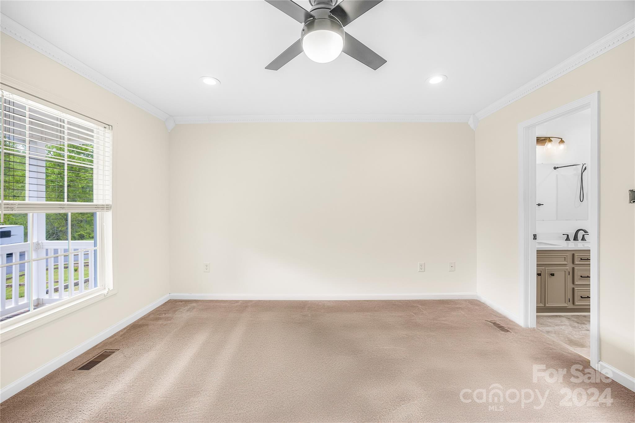 220 Shenandoah Loop Troutman, NC 28166 - Photo 15 of 26 an empty room with a window and a kitchen