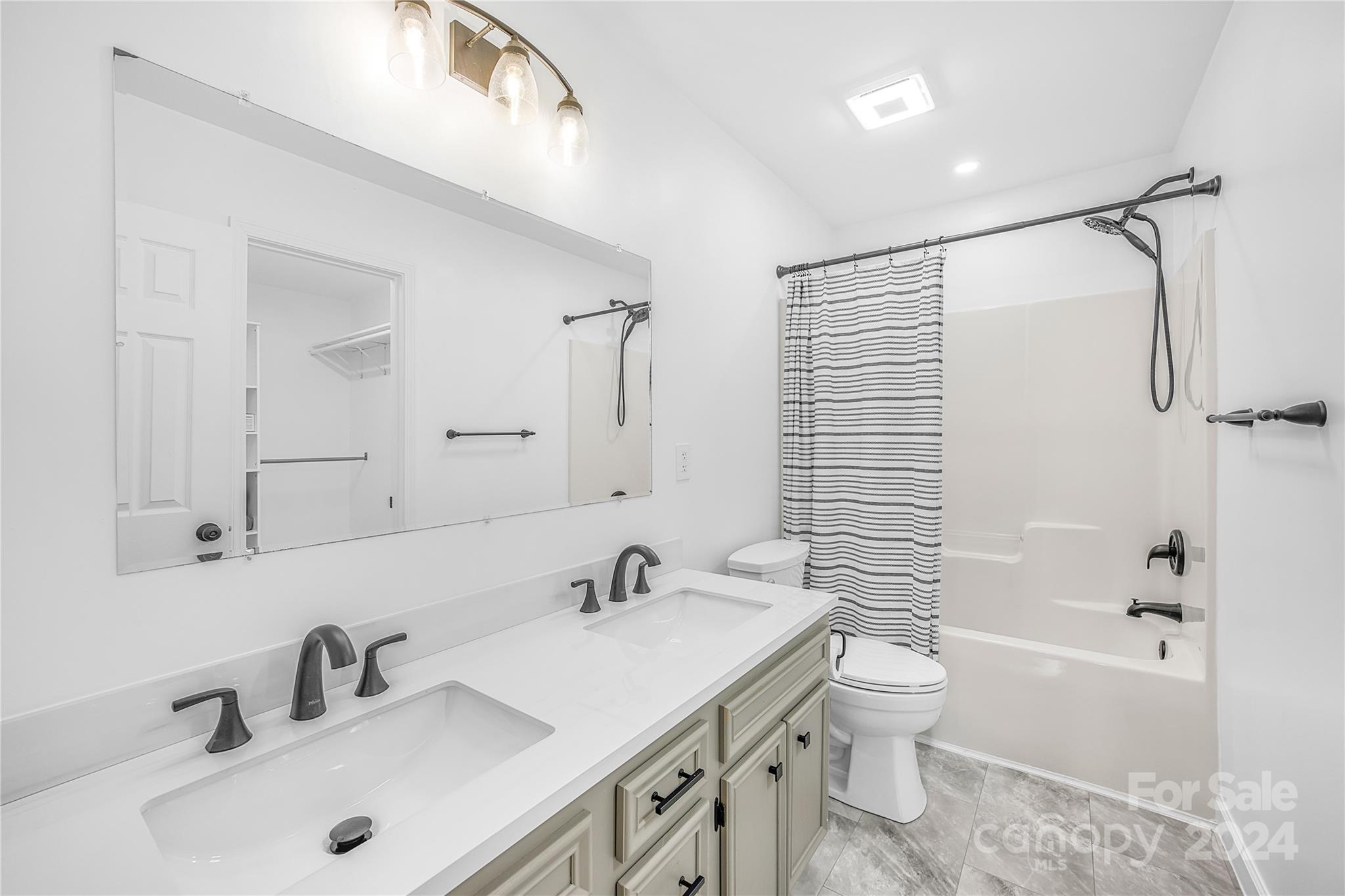 220 Shenandoah Loop Troutman, NC 28166 - Photo 17 of 26 a bathroom with a sink double vanity granite toilet tub and shower