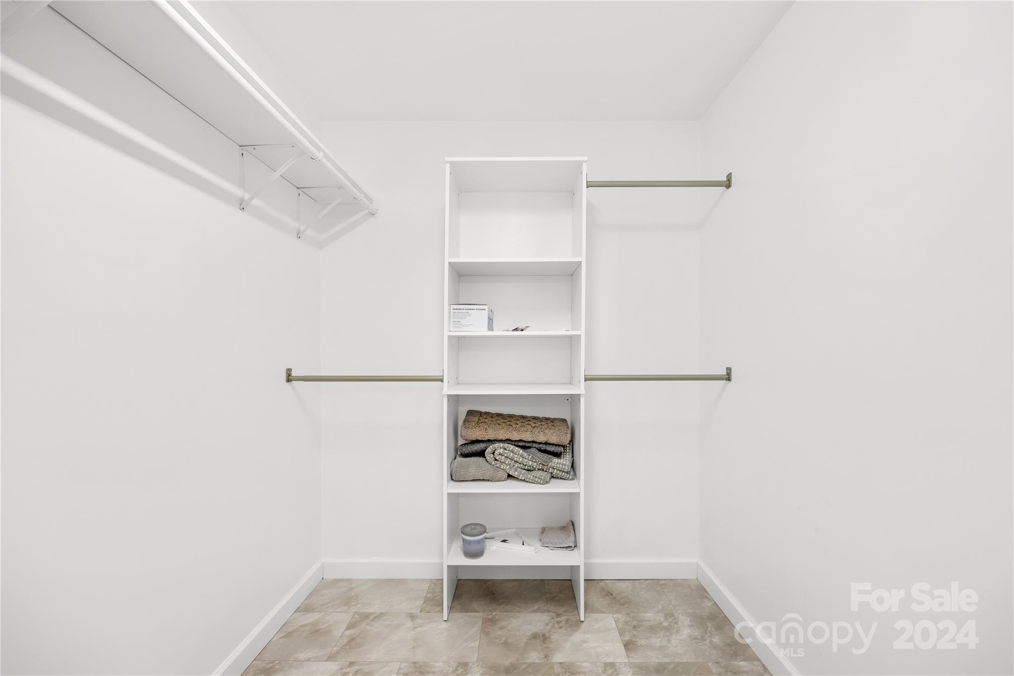 220 Shenandoah Loop Troutman, NC 28166 - Photo 18 of 26 a view of walk in closet with empty racks