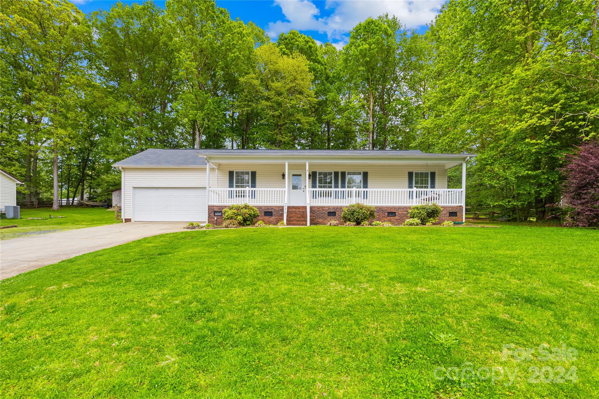 220 Shenandoah Loop Troutman, NC 28166 - Photo 2 of 26 a view of a house with a backyard and a patio