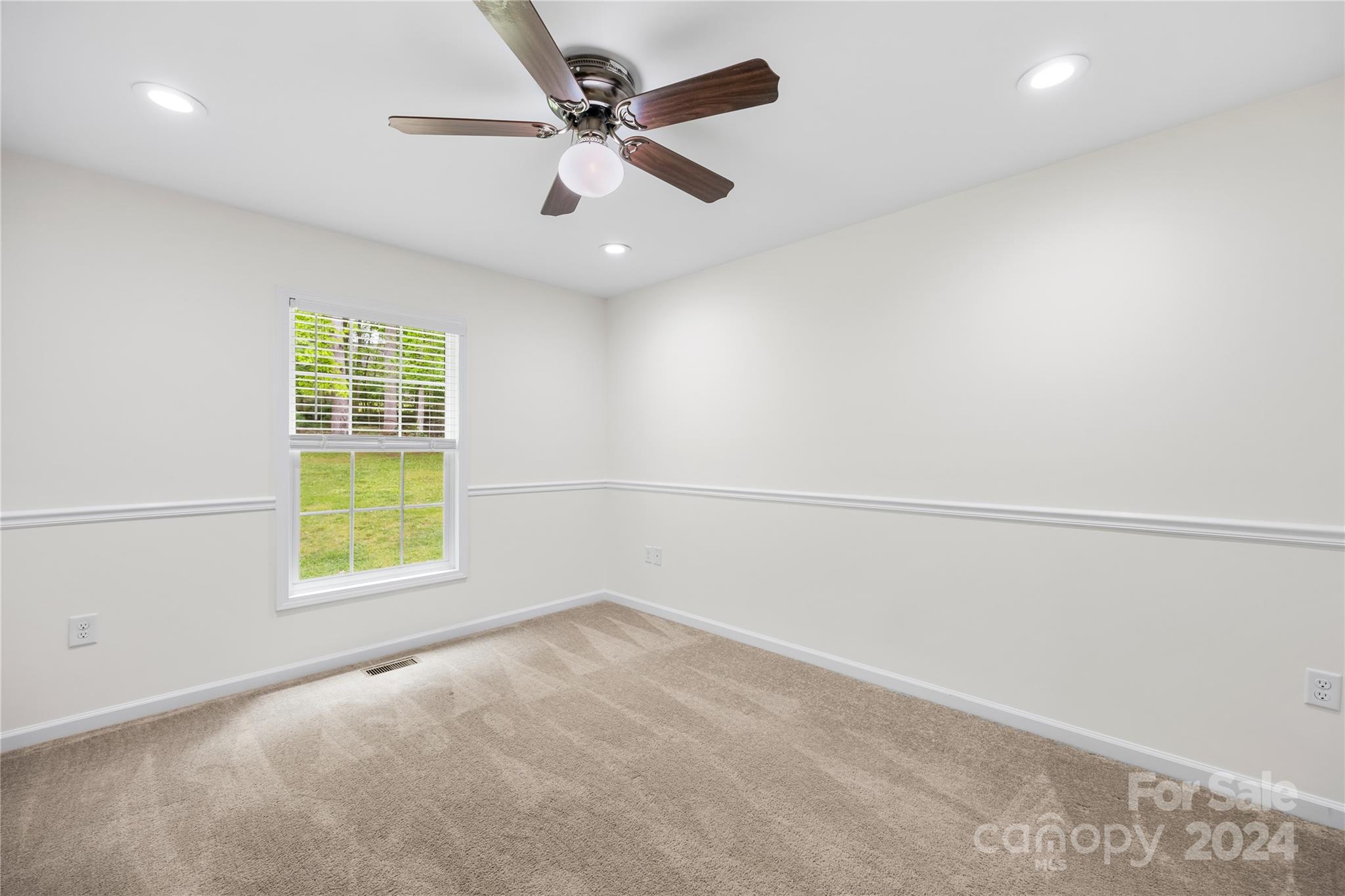220 Shenandoah Loop Troutman, NC 28166 - Photo 21 of 26 an empty room with windows and fan