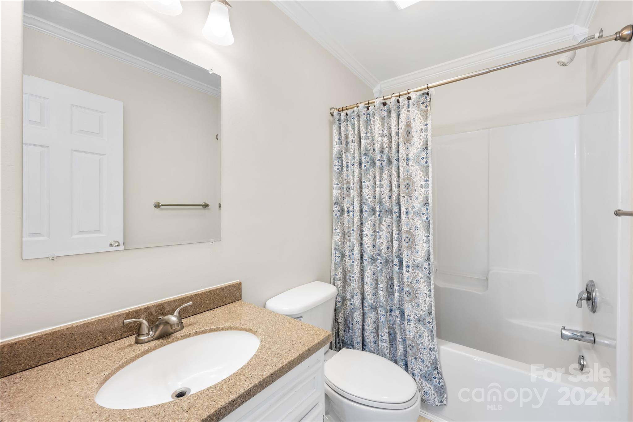 220 Shenandoah Loop Troutman, NC 28166 - Photo 22 of 26 a bathroom with a sink toilet and shower