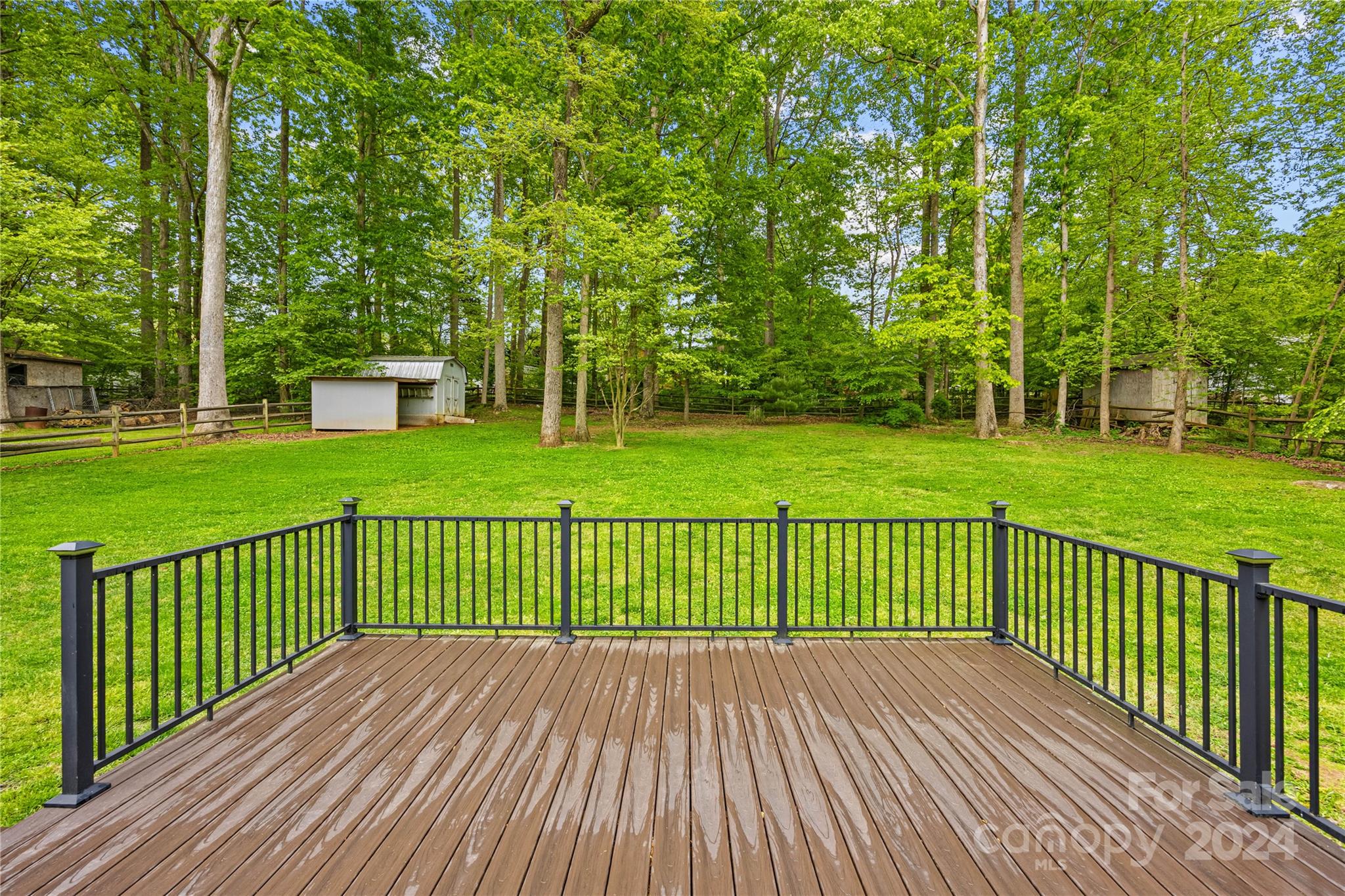 220 Shenandoah Loop Troutman, NC 28166 - Photo 23 of 26 a view of a wooden deck and a garden