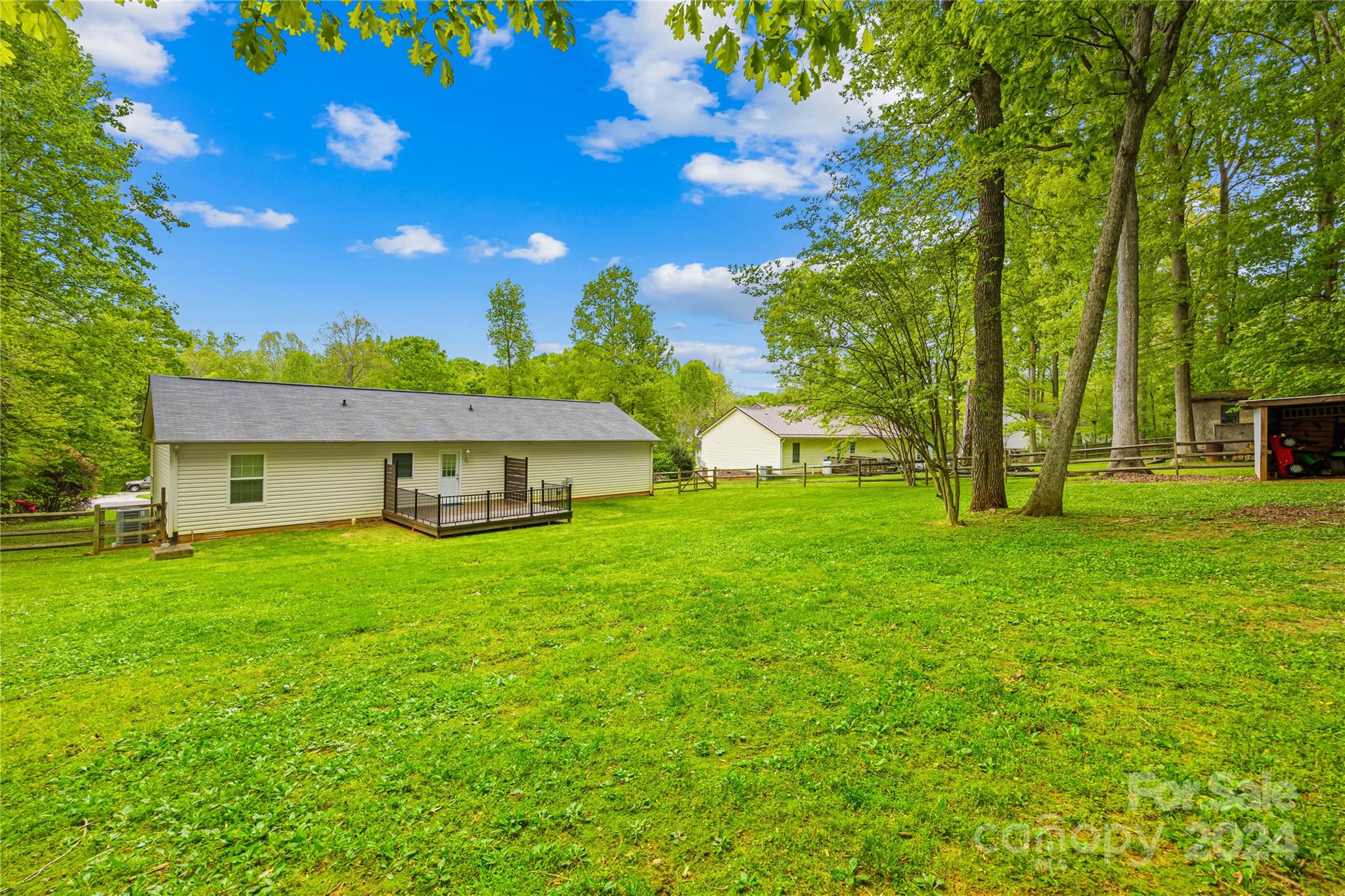 220 Shenandoah Loop Troutman, NC 28166 - Photo 26 of 26 a view of a house with a big yard and large trees