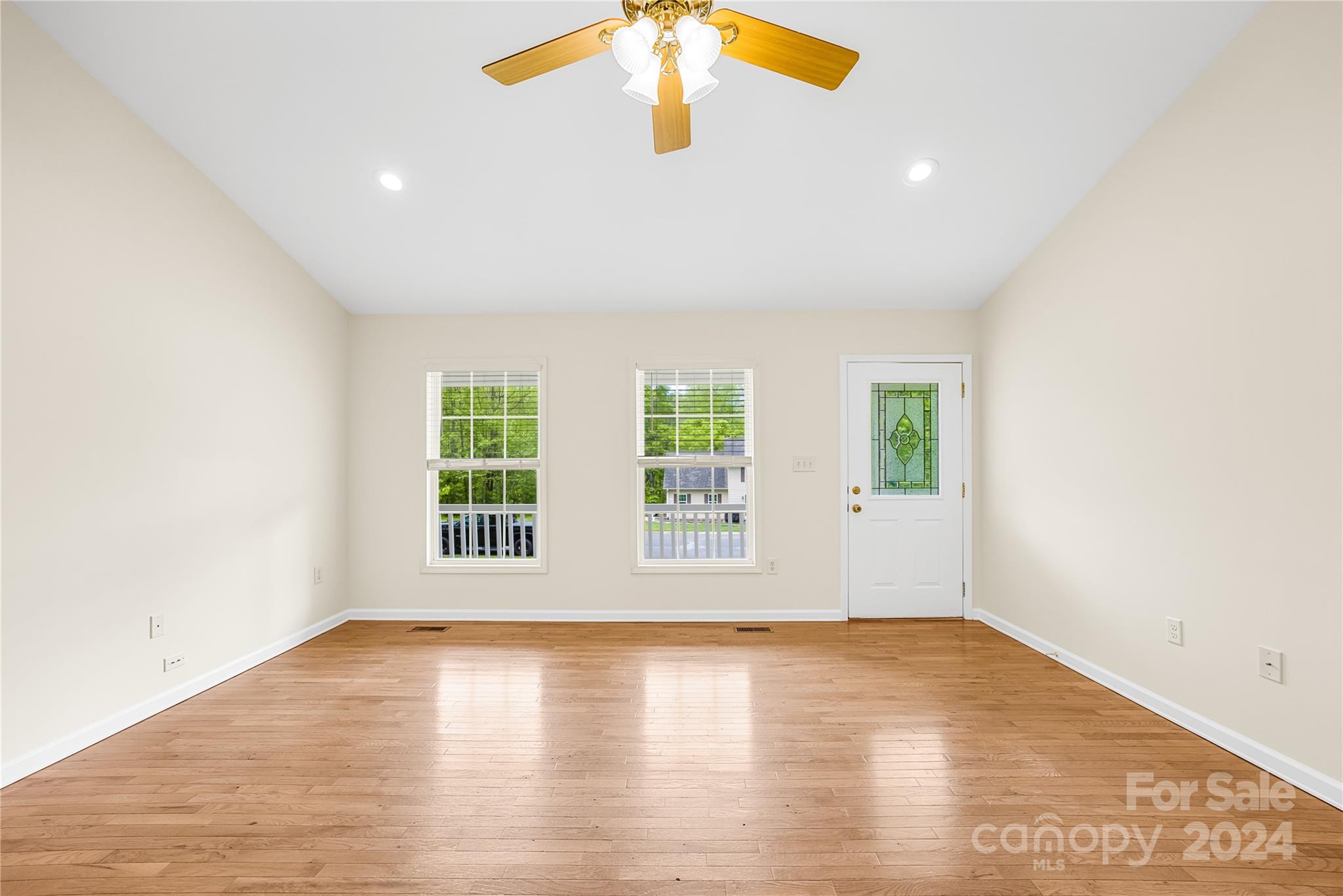 220 Shenandoah Loop Troutman, NC 28166 - Photo 7 of 26 an empty room with wooden floor and windows