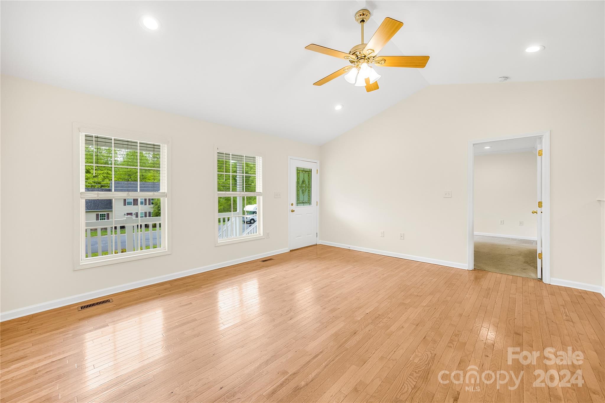 220 Shenandoah Loop Troutman, NC 28166 - Photo 8 of 26 a view of an empty room with window and wooden floor