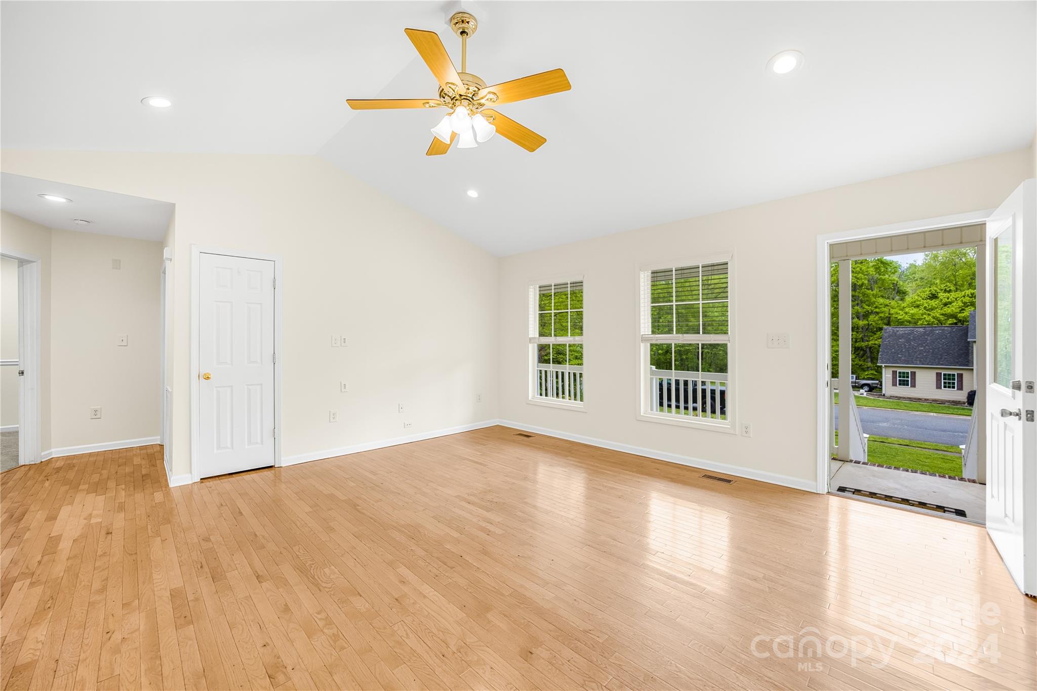 220 Shenandoah Loop Troutman, NC 28166 - Photo 9 of 26 a view of an empty room with a window and wooden floor