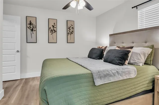 a bedroom with a bed and painting on the wall