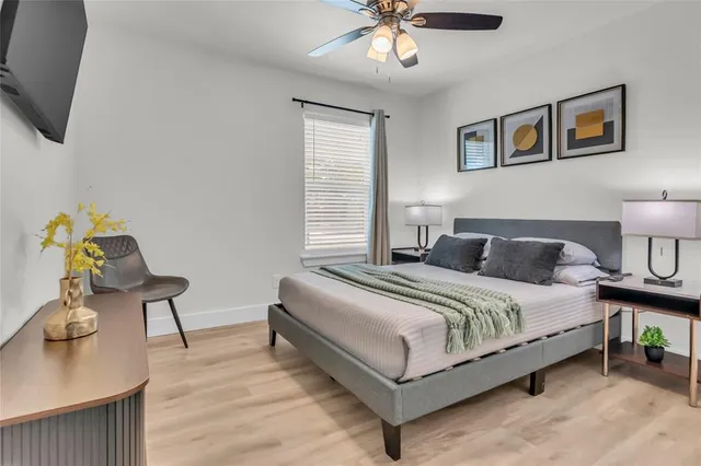 a bedroom with a bed and painting on the wall