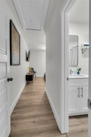 a view of a hallway with the wooden floor and staircase