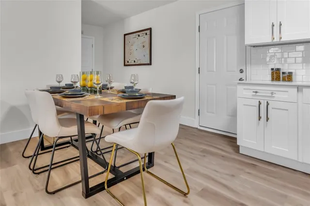 a view of a dining room with furniture and wooden floor