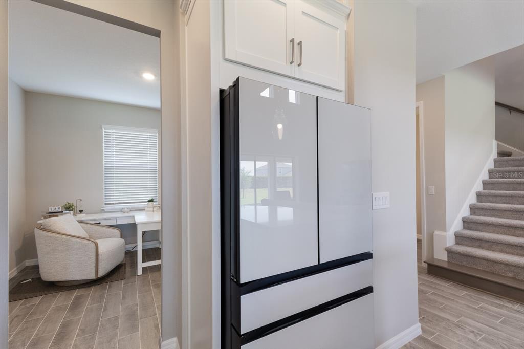 9312 Tequila Sunrise Drive Sarasota, FL 34241 - Photo 15 of 78 a view of a hallway with furniture and wooden floor