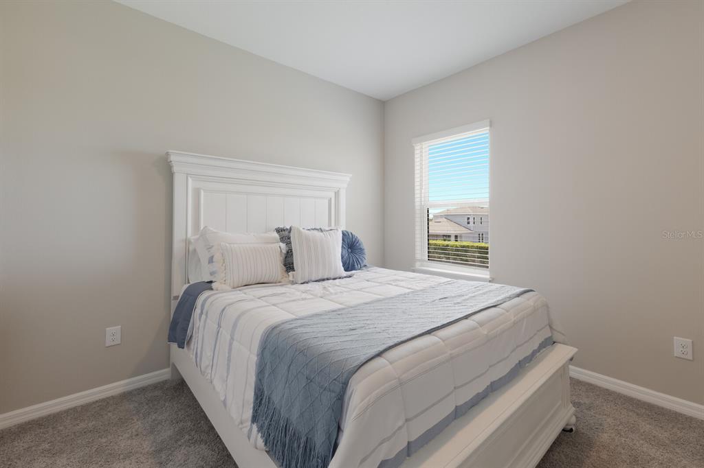 9312 Tequila Sunrise Drive Sarasota, FL 34241 - Photo 29 of 78 a bed sitting in a bedroom next to a window