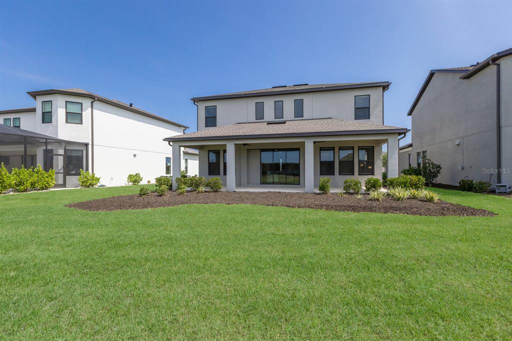 9312 Tequila Sunrise Drive Sarasota, FL 34241 - Photo 32 of 78 a view of house with a big yard and potted plants