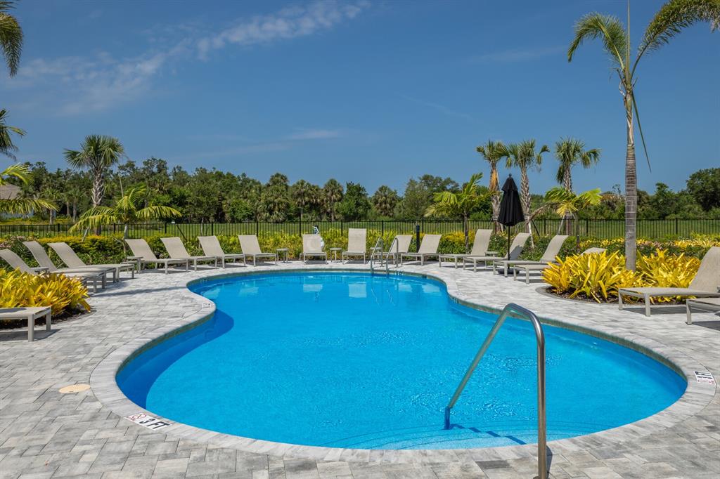 9312 Tequila Sunrise Drive Sarasota, FL 34241 - Photo 36 of 78 a view of a swimming pool with a lounge chair
