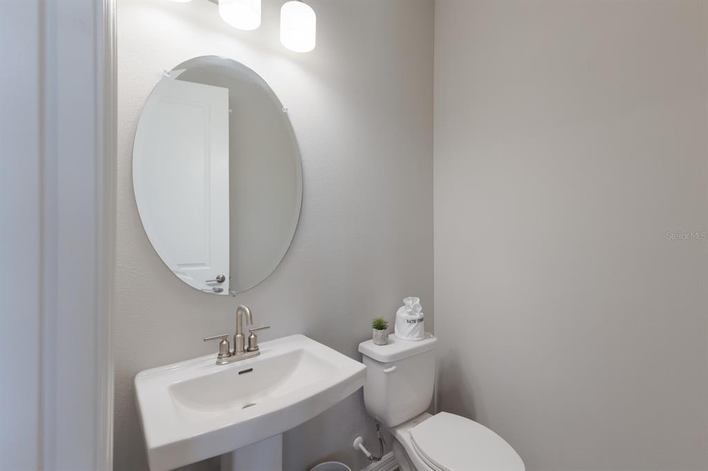 9312 Tequila Sunrise Drive Sarasota, FL 34241 - Photo 5 of 78 a bathroom with a toilet a sink and mirror