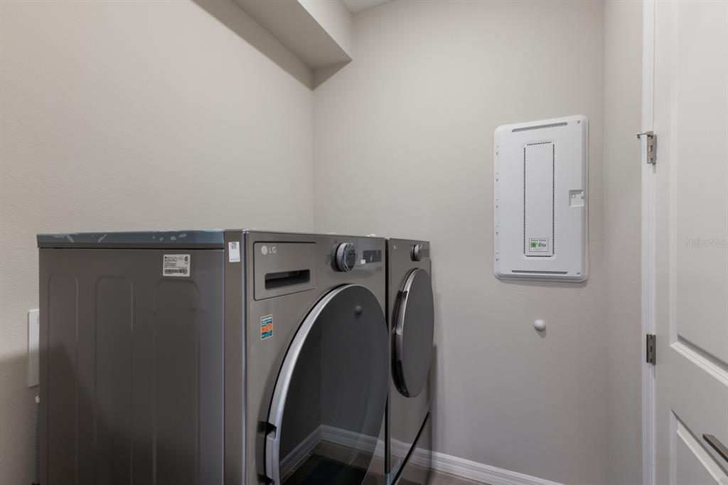9312 Tequila Sunrise Drive Sarasota, FL 34241 - Photo 6 of 78 a utility room with dryer and washer