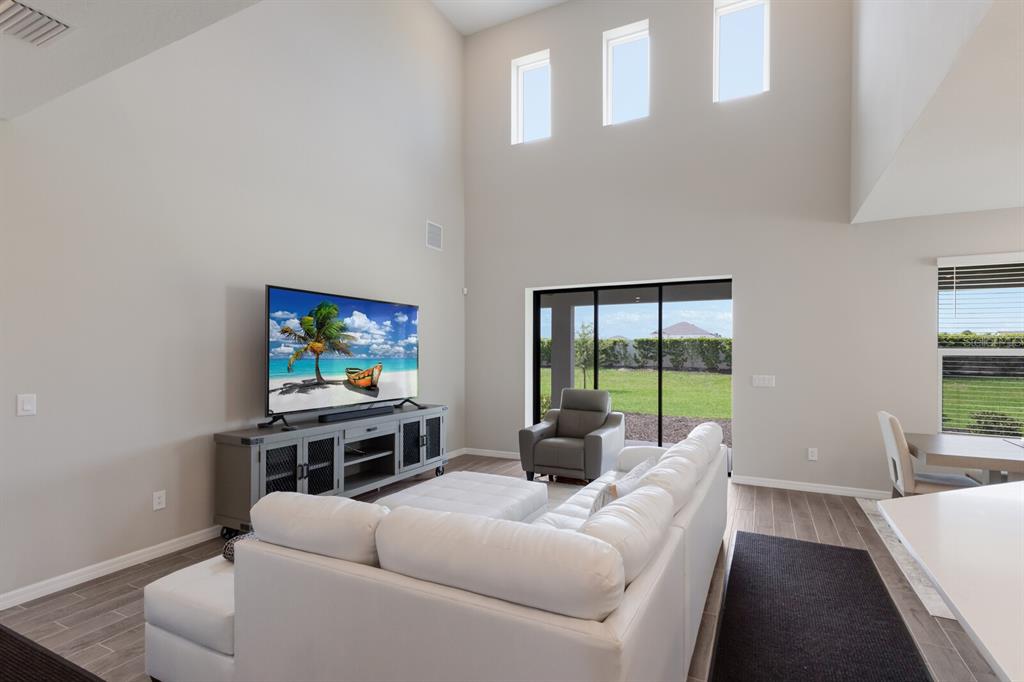 9312 Tequila Sunrise Drive Sarasota, FL 34241 - Photo 7 of 78 a living room with furniture and a flat screen tv