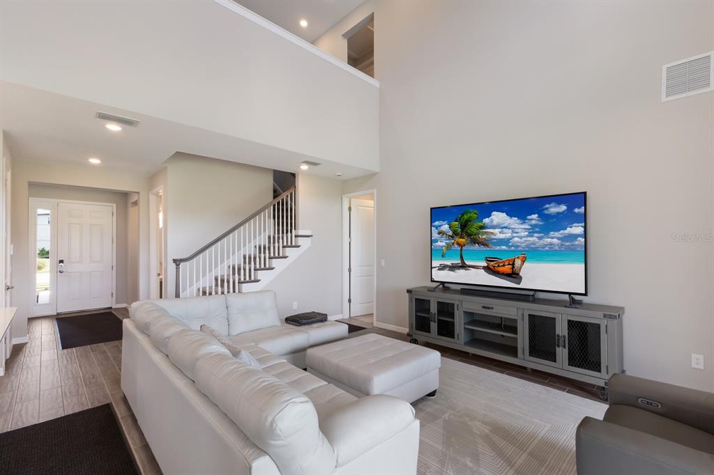 9312 Tequila Sunrise Drive Sarasota, FL 34241 - Photo 10 of 78 a living room with furniture and a flat screen tv