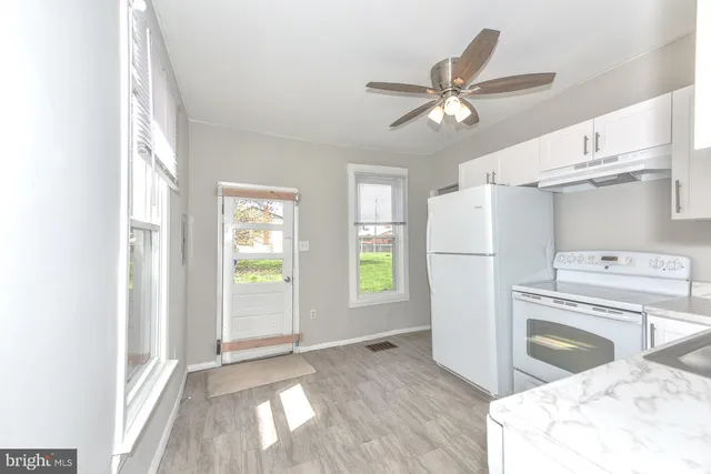 a kitchen with a refrigerator a sink and a window