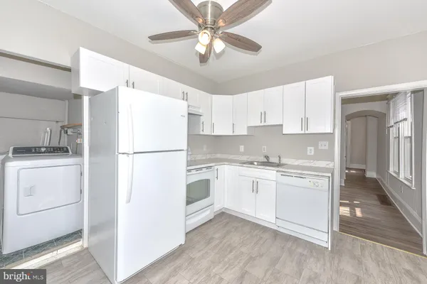 a kitchen with a refrigerator a sink and dishwasher