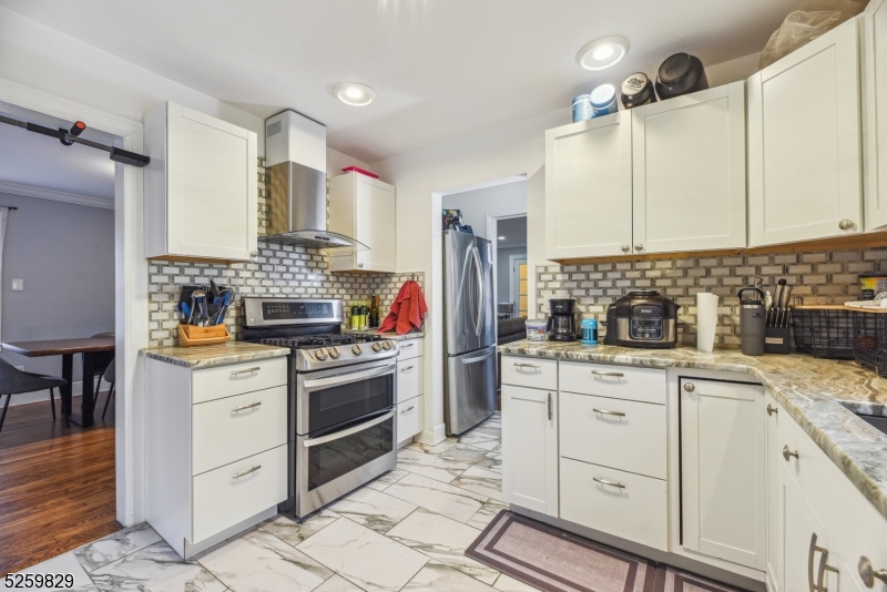 759 Ridgewood Road Millburn, NJ 07041 - Photo 11 of 36 a kitchen with white cabinets and appliances