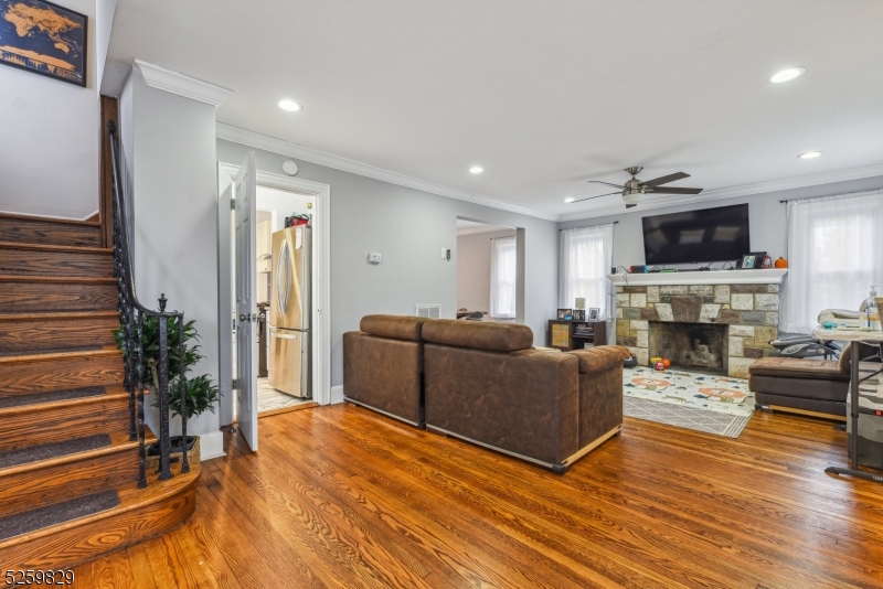 759 Ridgewood Road Millburn, NJ 07041 - Photo 2 of 36 a living room with furniture a fireplace a flat screen tv and a potted plant