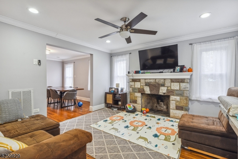 759 Ridgewood Road Millburn, NJ 07041 - Photo 5 of 36 a living room with furniture a flat screen tv and a fireplace