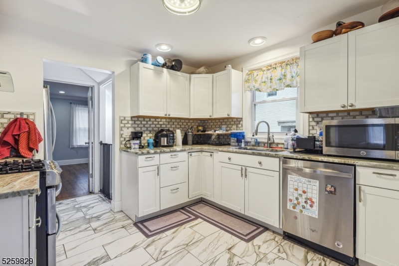 759 Ridgewood Road Millburn, NJ 07041 - Photo 9 of 36 a kitchen with granite countertop a sink stove and cabinets