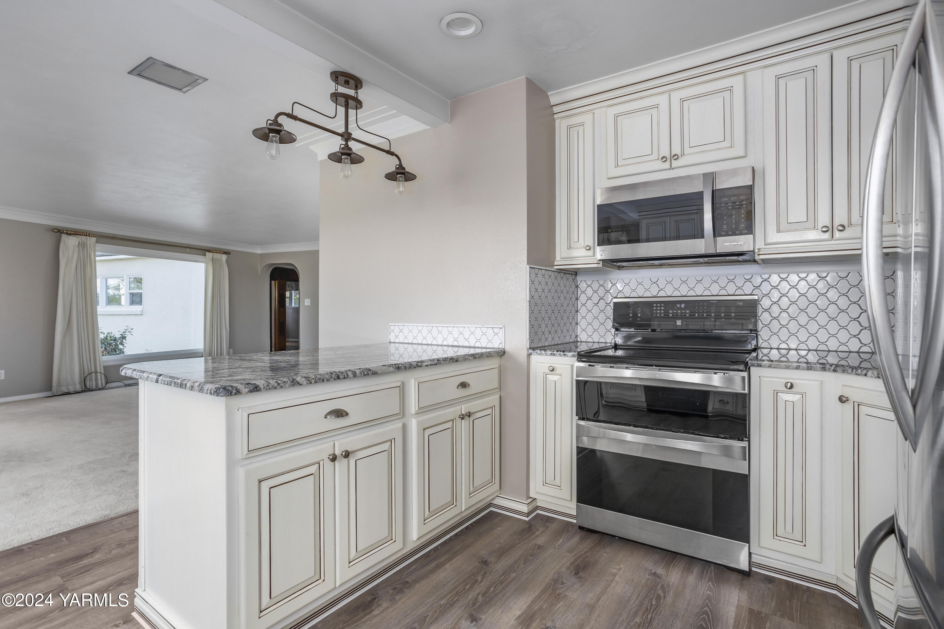 149402 McCreadie Road Prosser, WA 99350 - Photo 12 of 58 a kitchen with stainless steel appliances granite countertop a stove microwave and cabinets
