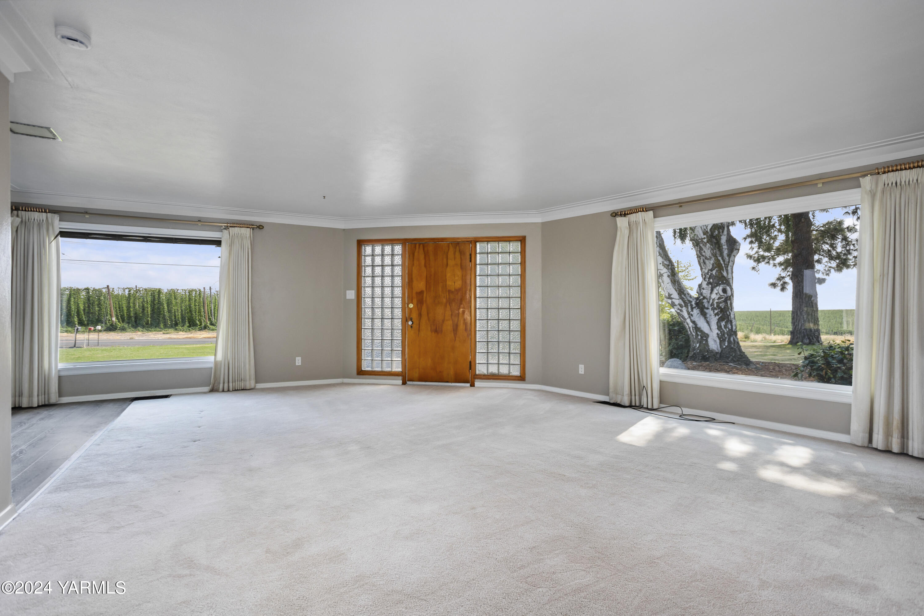 149402 McCreadie Road Prosser, WA 99350 - Photo 6 of 58 a view of an empty room with a fireplace and a large window