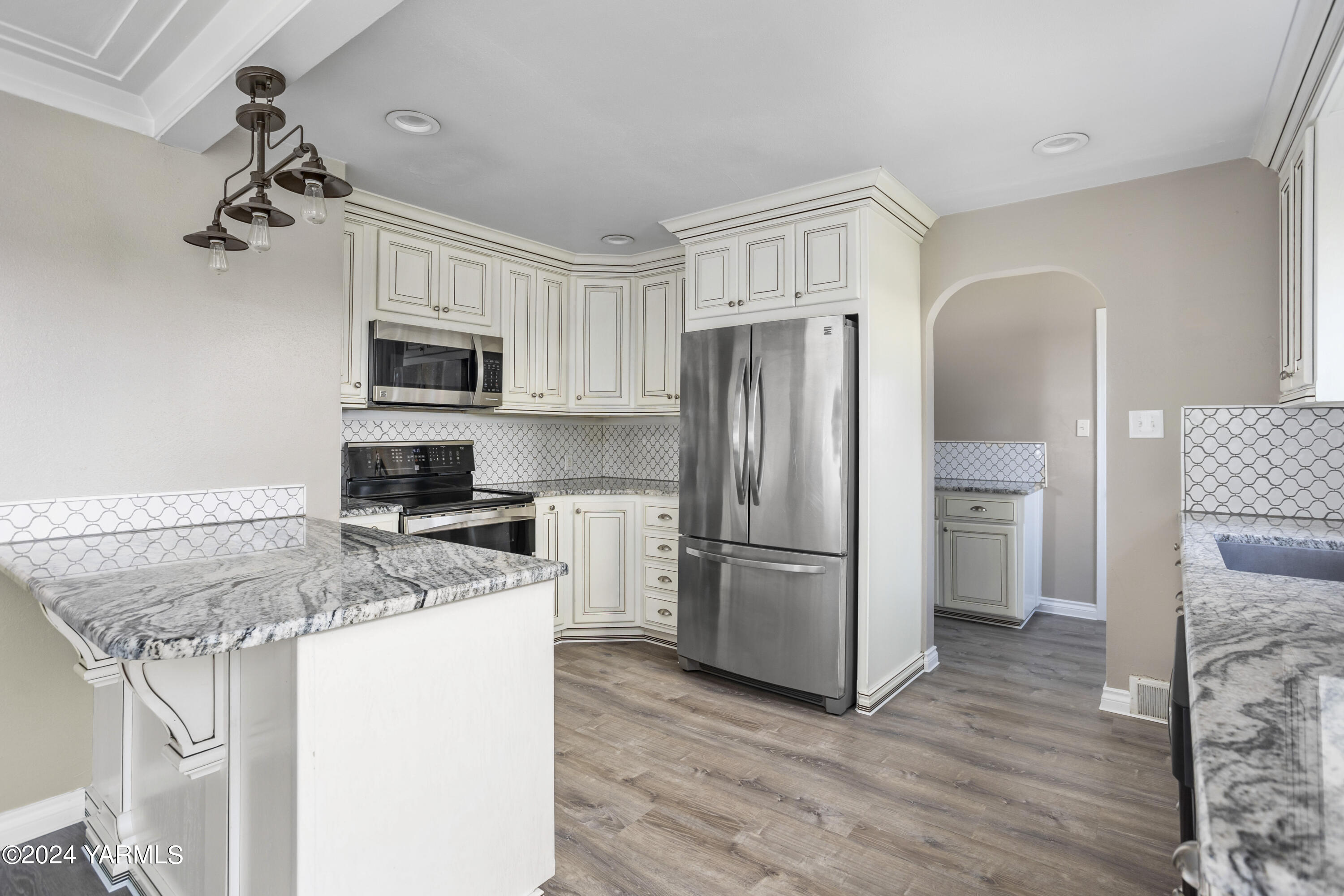 149402 McCreadie Road Prosser, WA 99350 - Photo 10 of 58 a kitchen with a refrigerator a microwave and cabinets
