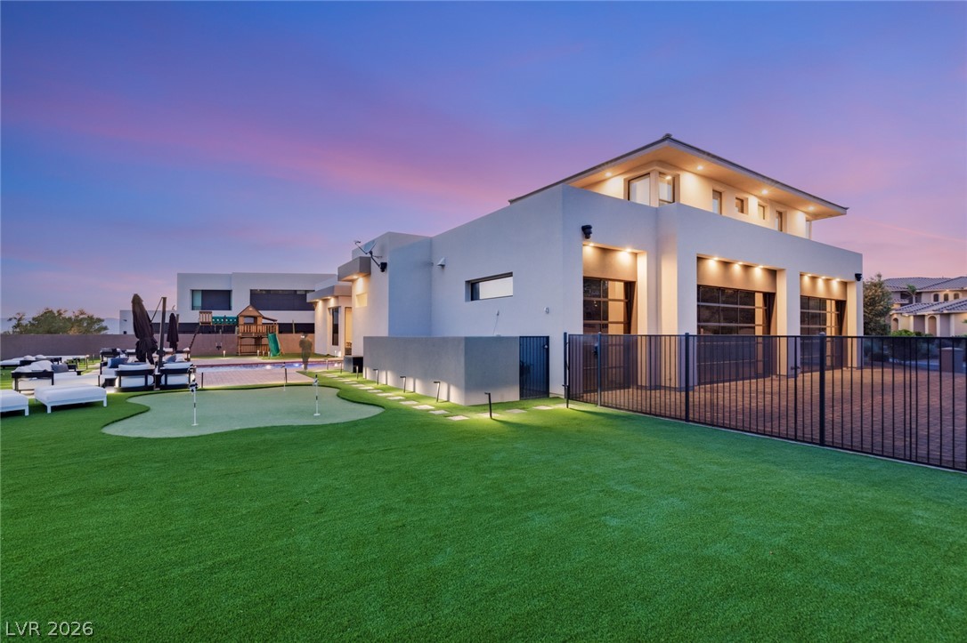 5 Crystal Tree Pass Henderson, NV 89052 - Photo 59 of 67 Modern architecture meets outdoor recreation with a lush putting green and resort-style lounging.