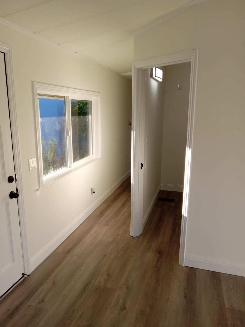 44 The Trees Drive, Unit 44 Concord, CA 94518 - Photo 17 of 22 an empty room with wooden floor and windows