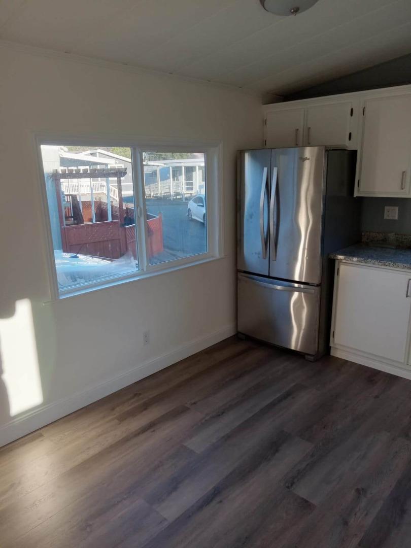 44 The Trees Drive, Unit 44 Concord, CA 94518 - Photo 19 of 22 a view of a kitchen with wooden floor and refrigerator