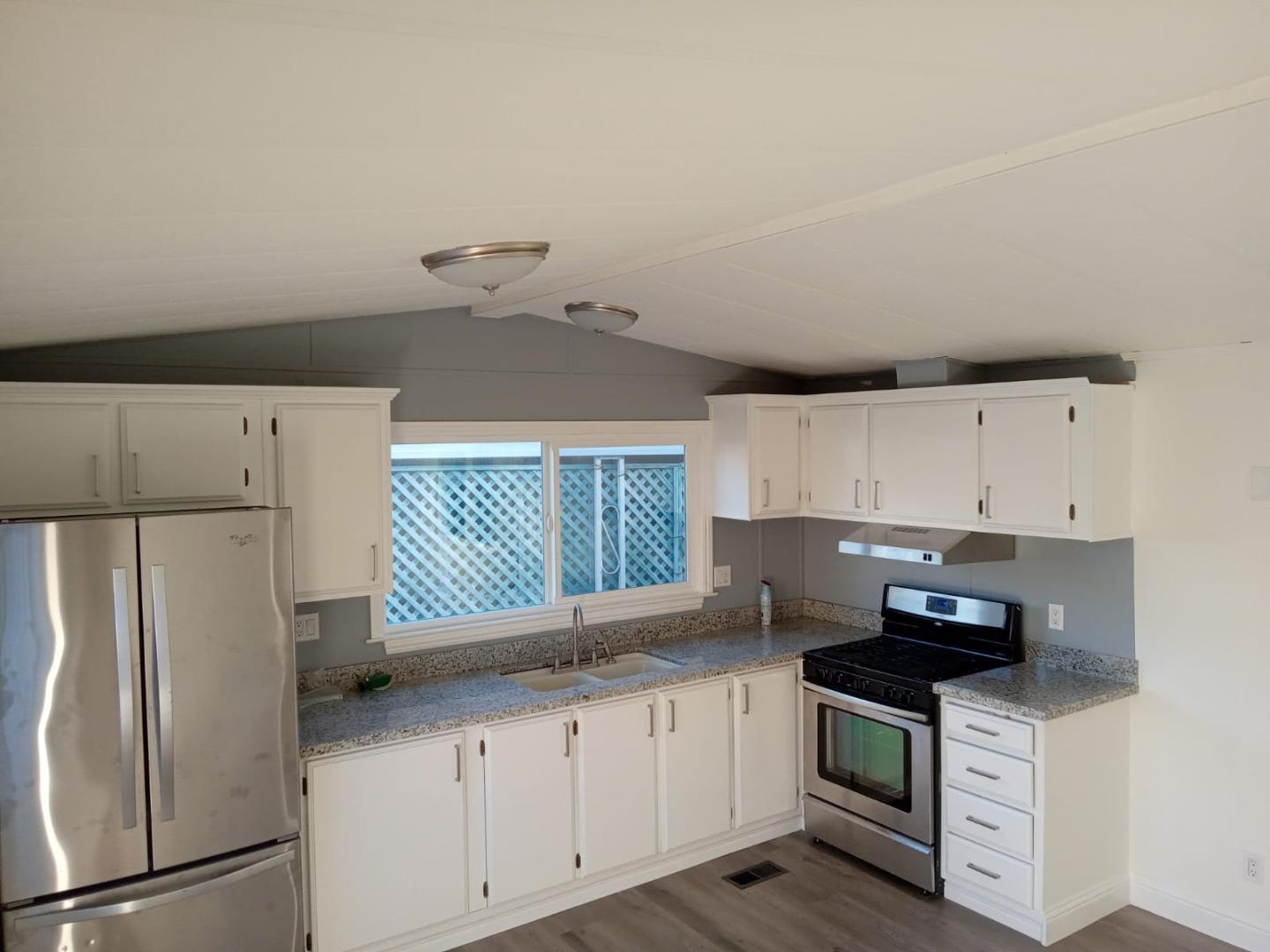 44 The Trees Drive, Unit 44 Concord, CA 94518 - Photo 20 of 22 a kitchen with granite countertop a refrigerator sink and stove