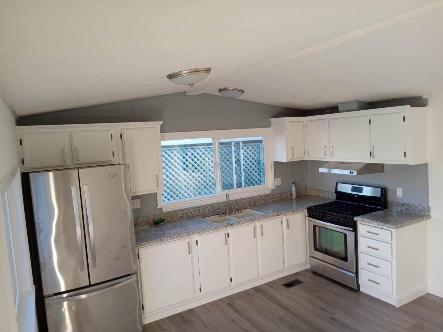 44 The Trees Drive, Unit 44 Concord, CA 94518 - Photo 8 of 22 a kitchen with a refrigerator a stove a microwave and cabinets