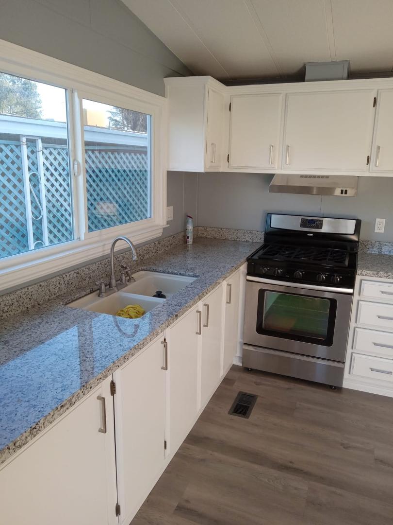 44 The Trees Drive, Unit 44 Concord, CA 94518 - Photo 9 of 22 a kitchen with granite countertop a stove a sink and a granite counter tops