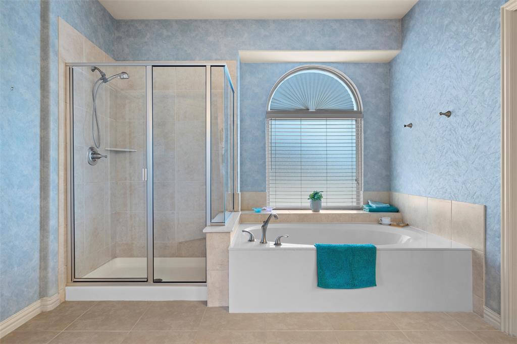 2803 Pino Grand Prairie, TX 75054 - Photo 13 of 36 a bath tub sitting in a bathroom next to a window