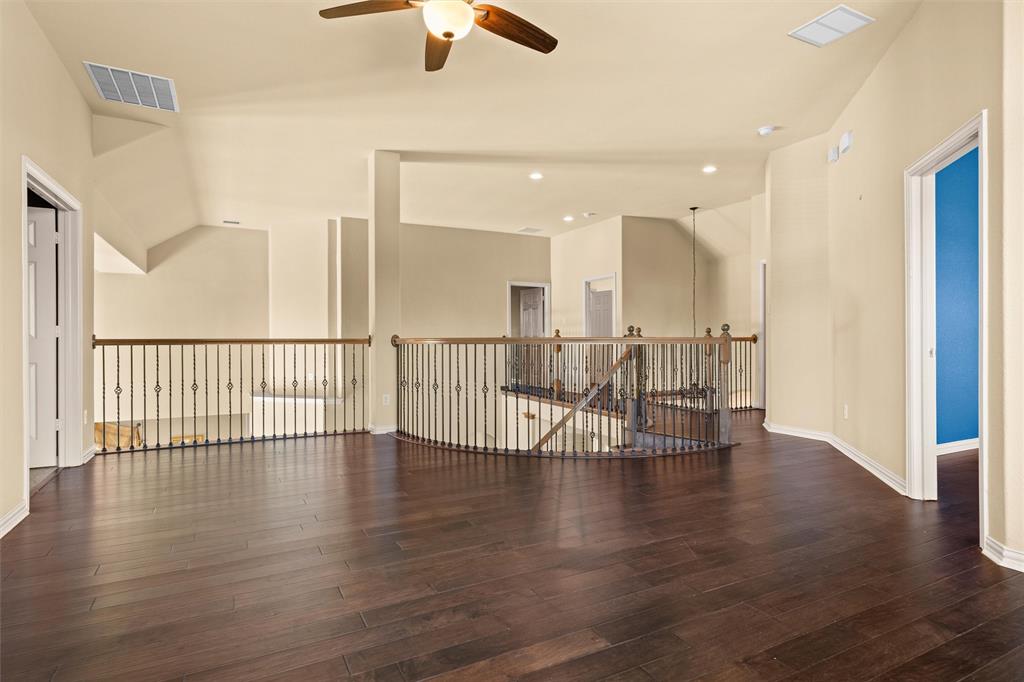 2803 Pino Grand Prairie, TX 75054 - Photo 16 of 36 an empty room with wooden floor and windows