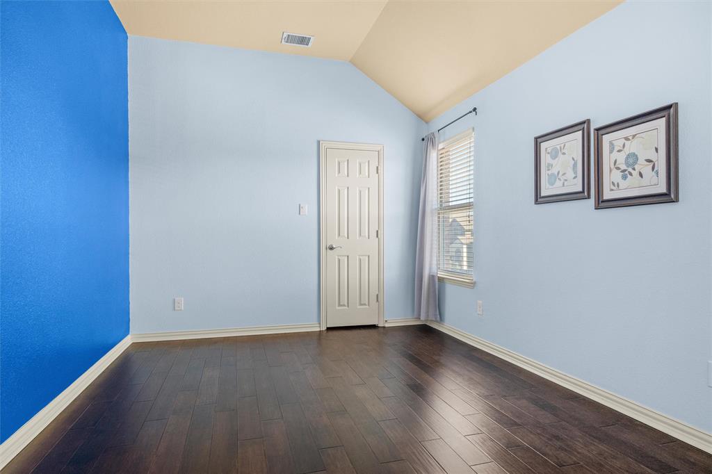 2803 Pino Grand Prairie, TX 75054 - Photo 18 of 36 an empty room with wooden floor and windows