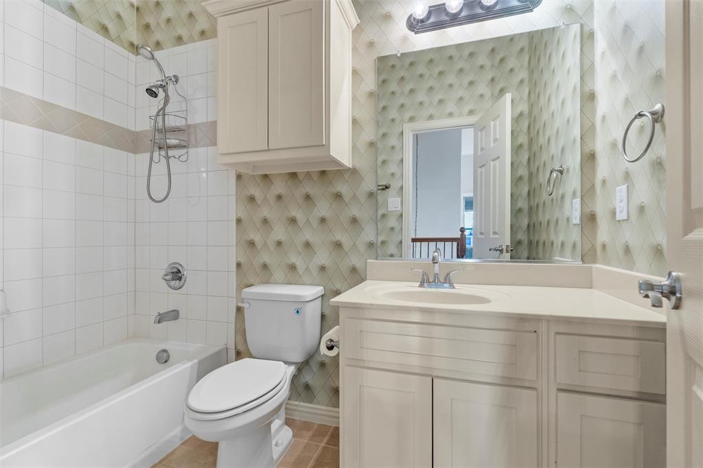 2803 Pino Grand Prairie, TX 75054 - Photo 19 of 36 a bathroom with a sink toilet vanity and shower