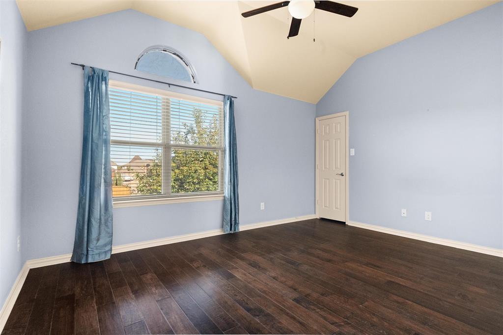 2803 Pino Grand Prairie, TX 75054 - Photo 20 of 36 an empty room with wooden floor chandelier fan and windows