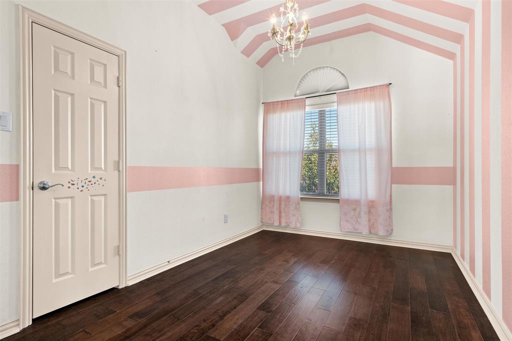 2803 Pino Grand Prairie, TX 75054 - Photo 21 of 36 wooden floor in an empty room with a window