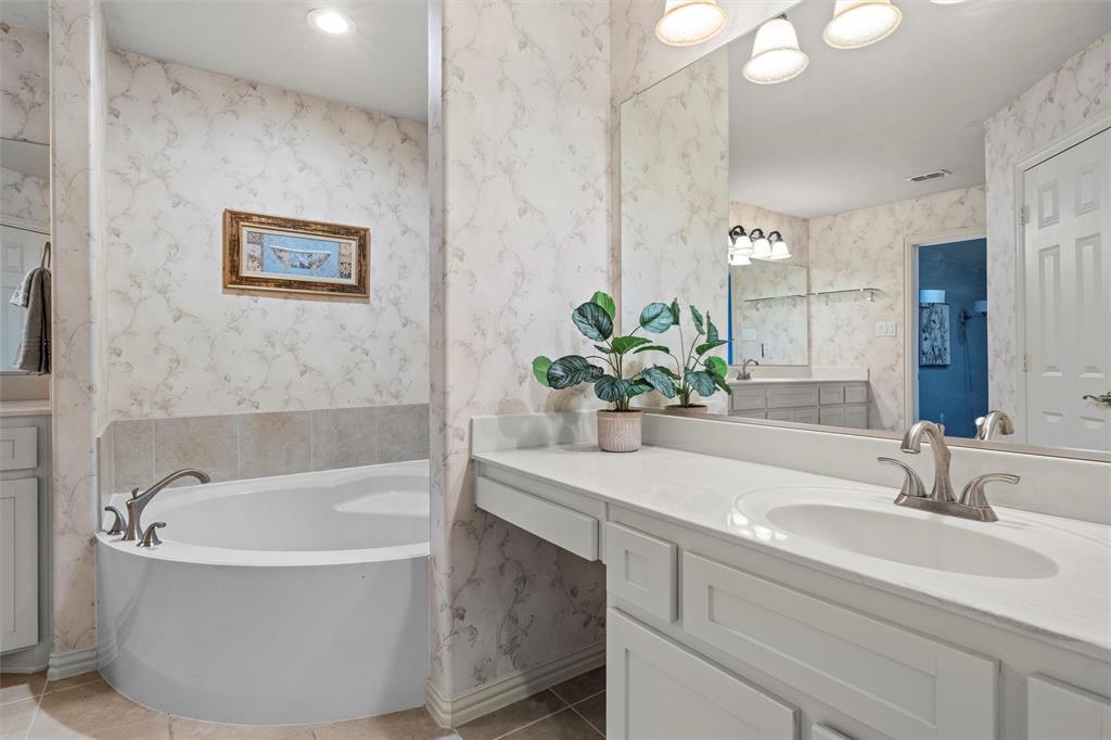 2803 Pino Grand Prairie, TX 75054 - Photo 25 of 36 a bathroom with a bathtub and a sink