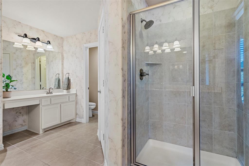 2803 Pino Grand Prairie, TX 75054 - Photo 26 of 36 a bathroom with a double vanity sink mirror and shower