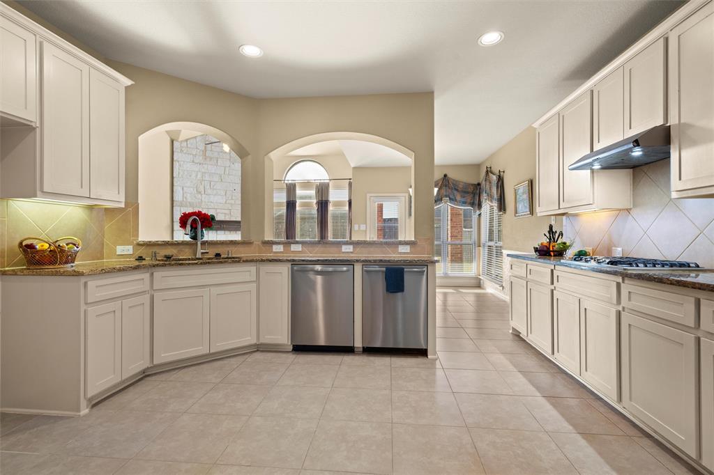 2803 Pino Grand Prairie, TX 75054 - Photo 9 of 36 a kitchen with white cabinets a sink and appliances
